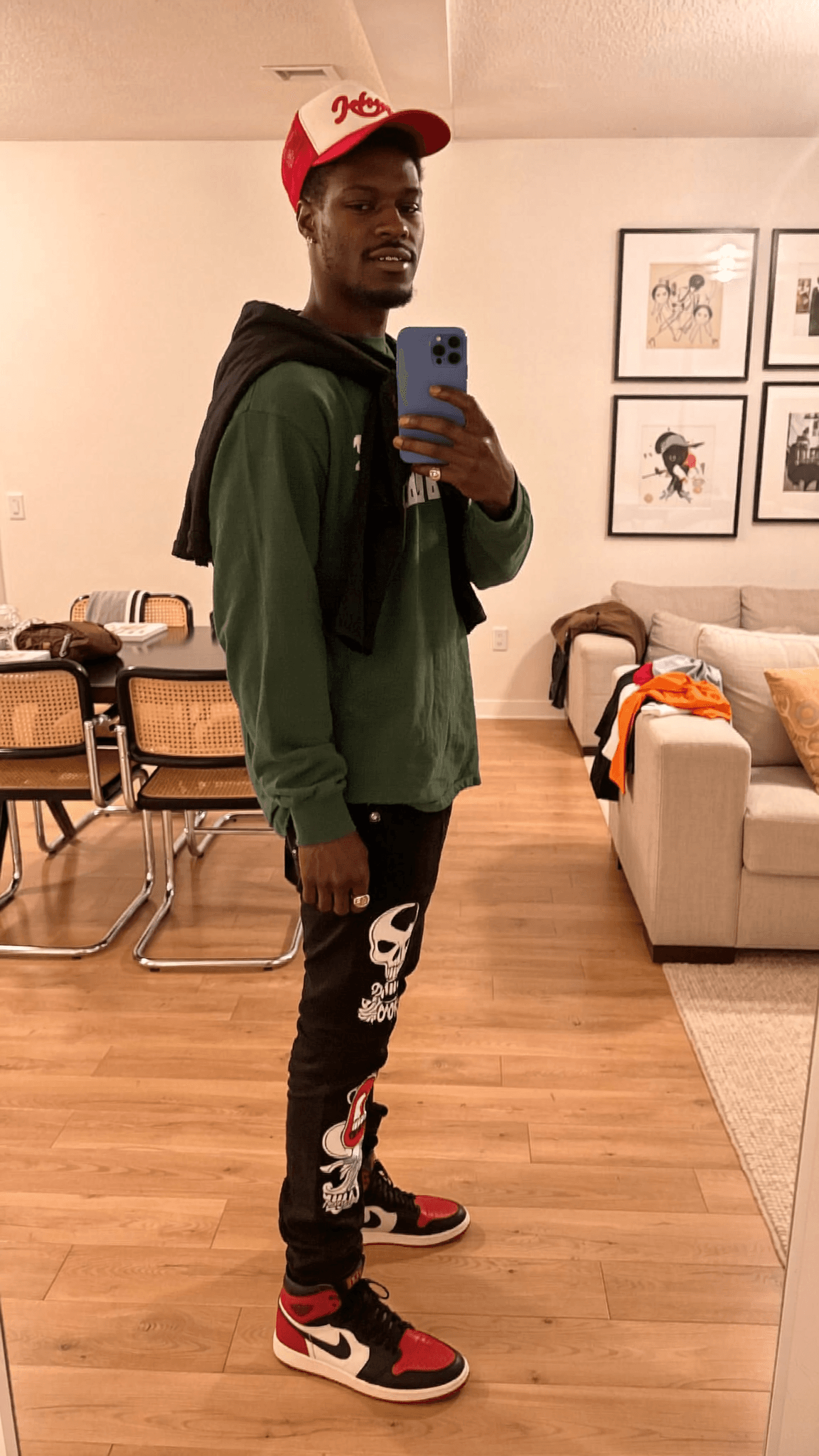 A person wearing casual athleisure attire poses in a generic room setting.