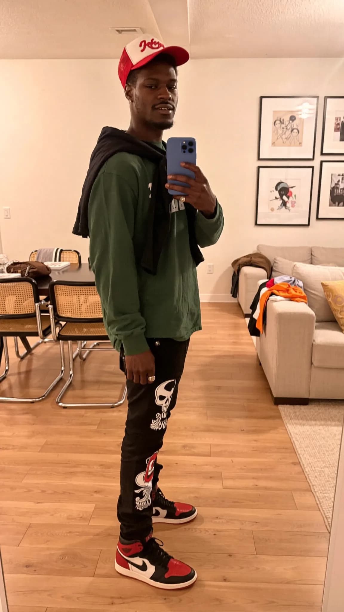 A person wearing casual athleisure attire poses in a generic room setting.
