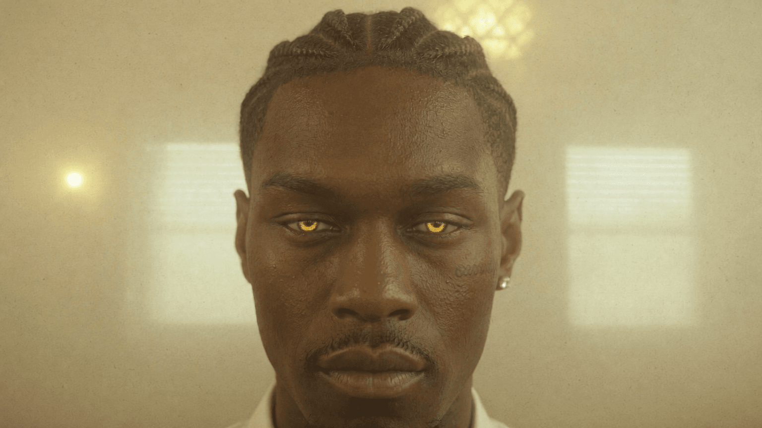 A man with dark skin and braided hair is posing in a studio setting, exuding confidence.