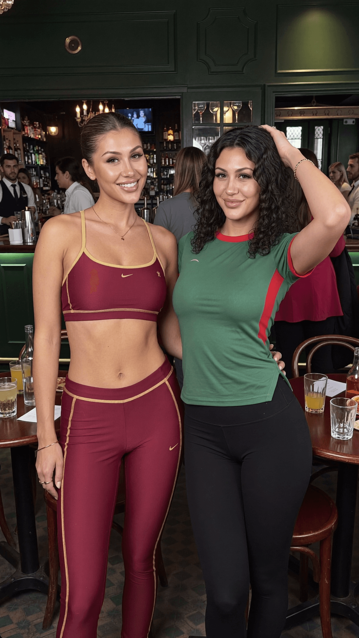 Two women in athletic attire pose together at a club.