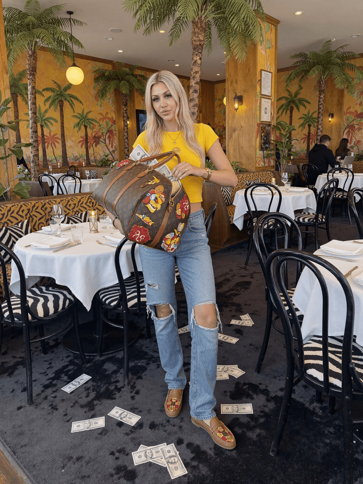 A woman in casual attire stands confidently in a restaurant, holding money and surrounded by scattered bills on the floor.