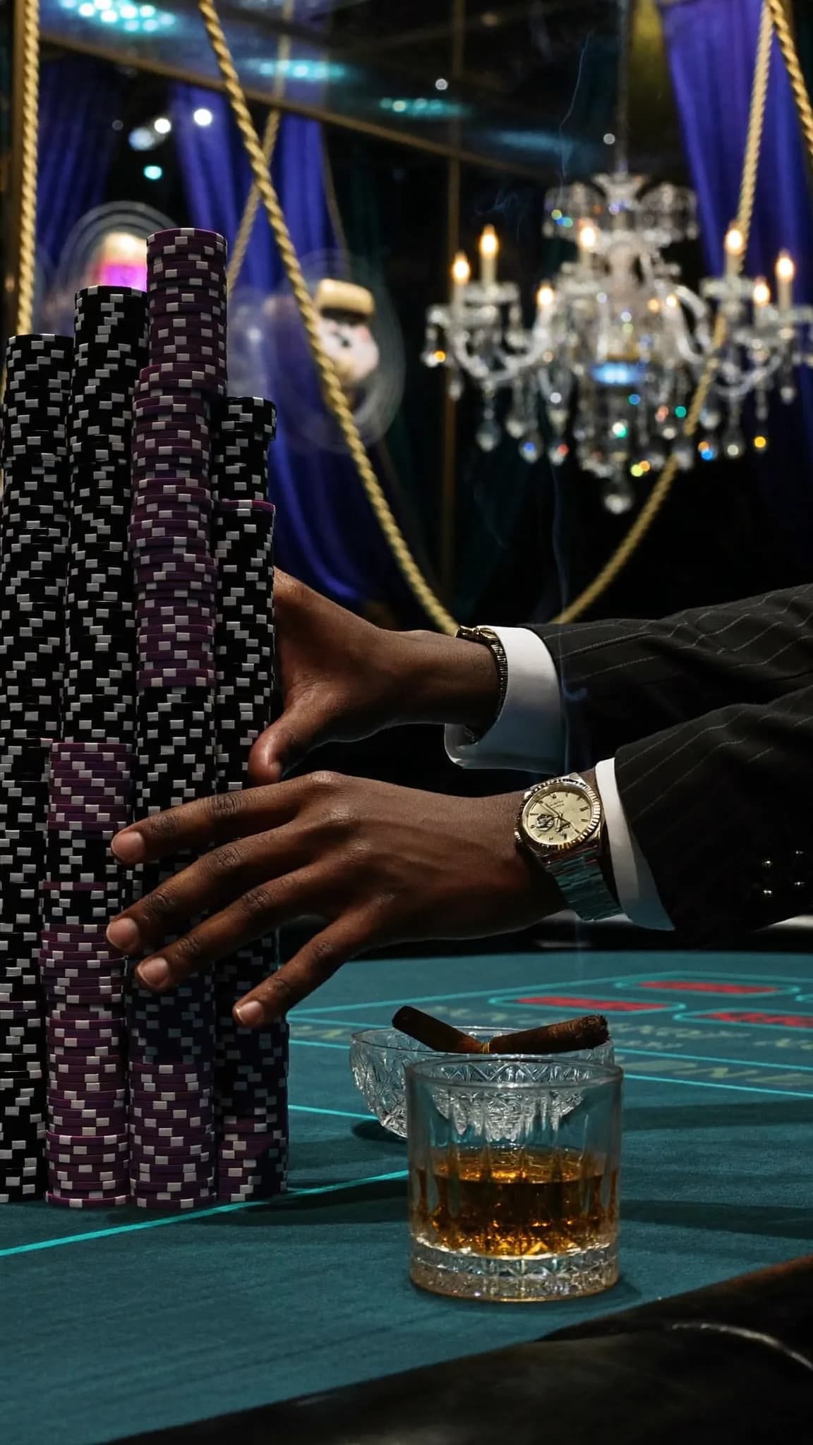 A person in formal attire is seated at a casino table with poker chips and a cigar, suggesting an atmosphere of luxury and leisure.