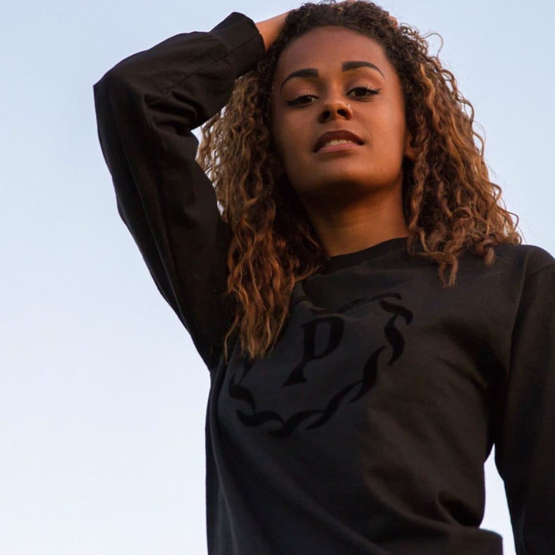 The apparel line — tonal monogram longsleeve, golden hour.