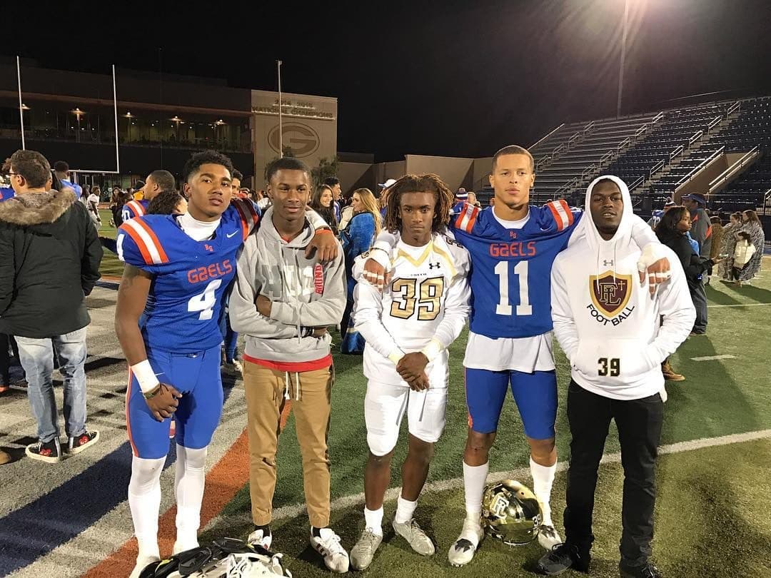 Under the Gorman lights — Gaels #4 and #11 with the crew after the win.